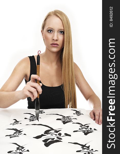 Blond woman writing Chinese Calligraphy: LOVE