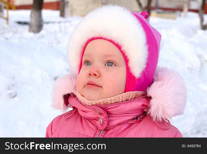 Pretty little girl in winter outerwear - outdoor portrait. Pretty little girl in winter outerwear - outdoor portrait.