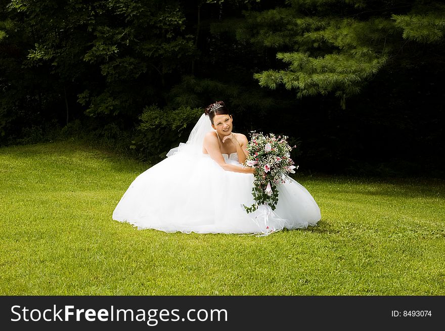 White Bride at her wedding posing with veil