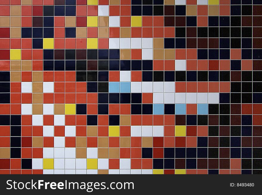 Colorful mosaic tiled wall of new danish building. Reds, yellow, blue, brown, white and more.
