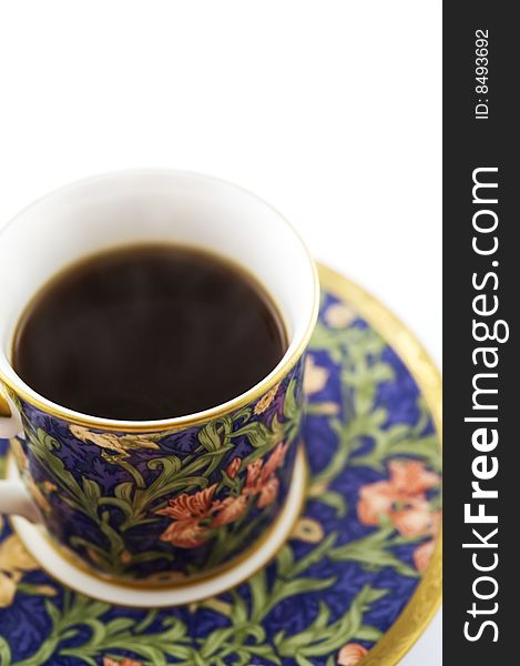 Black coffee in colorful cup and saucer