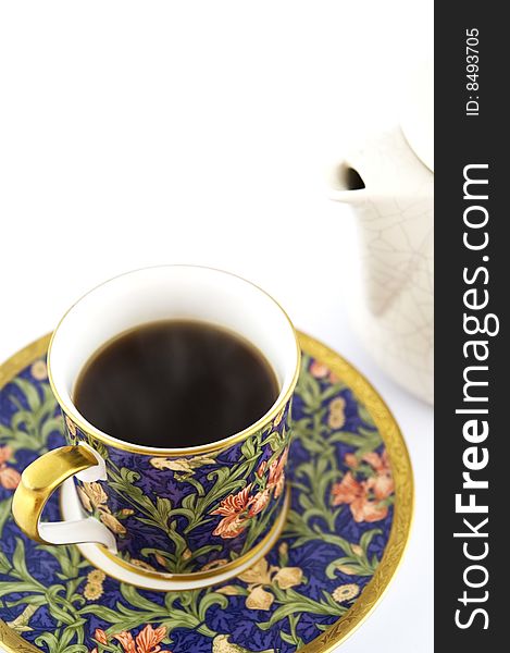 Black coffee in colorful cup, saucer and pot