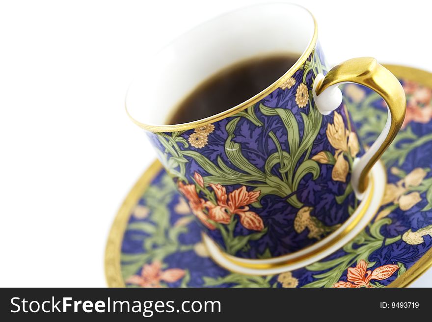 Black coffee in colorful cup and saucer