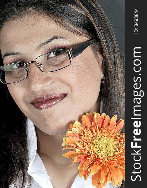 Closeup of girl with flower in the studio