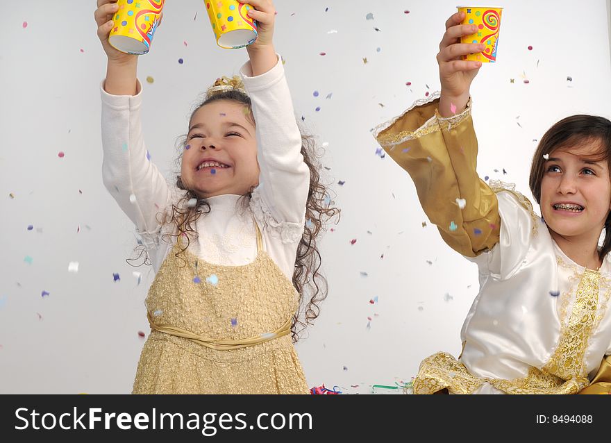 A child and a little girl are playing throwing confetti. A child and a little girl are playing throwing confetti