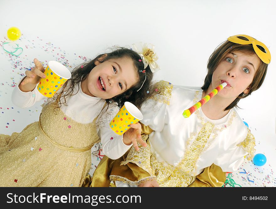 A child and a little girl are playing throwing confetti. A child and a little girl are playing throwing confetti