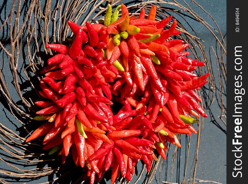A wreath made of hot, red chili peppers. A wreath made of hot, red chili peppers