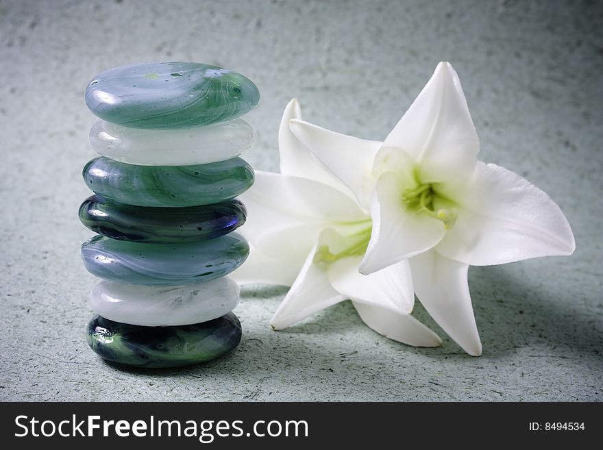 Stack of zen stones and lilum flower. Stack of zen stones and lilum flower.