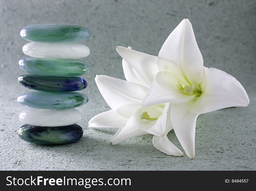 Stack of zen stones and lilum flower. Stack of zen stones and lilum flower.
