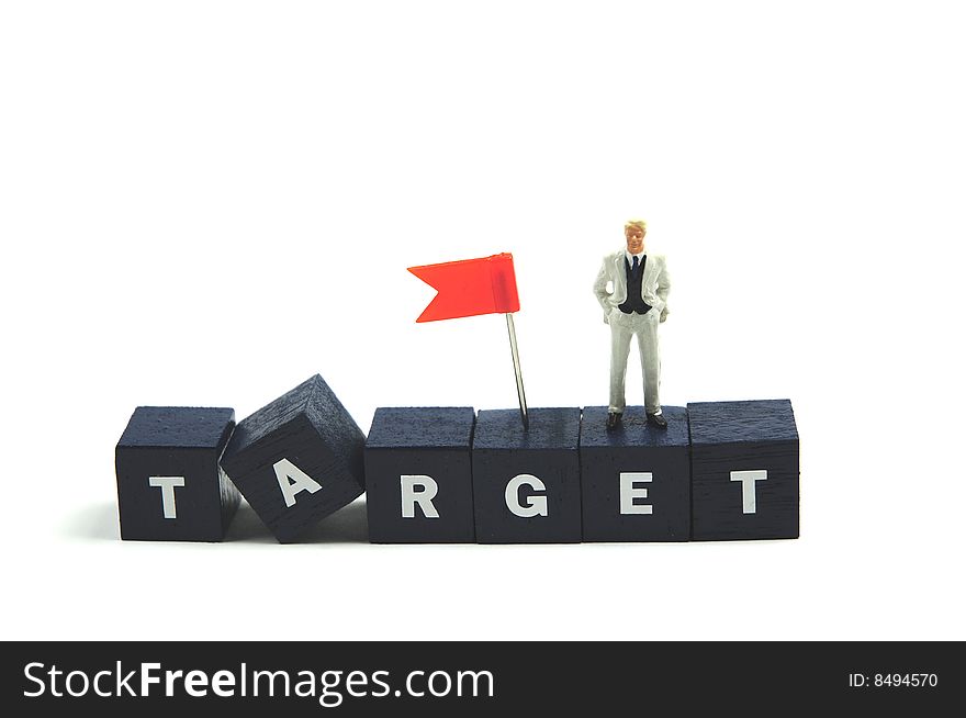 A businessman standing on the word target. A businessman standing on the word target