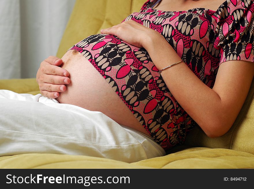 Pregnant lady resting on couch