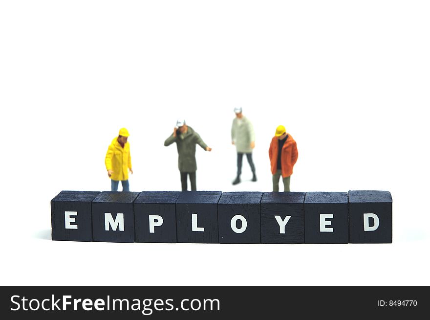 Some figurines behind the word employed