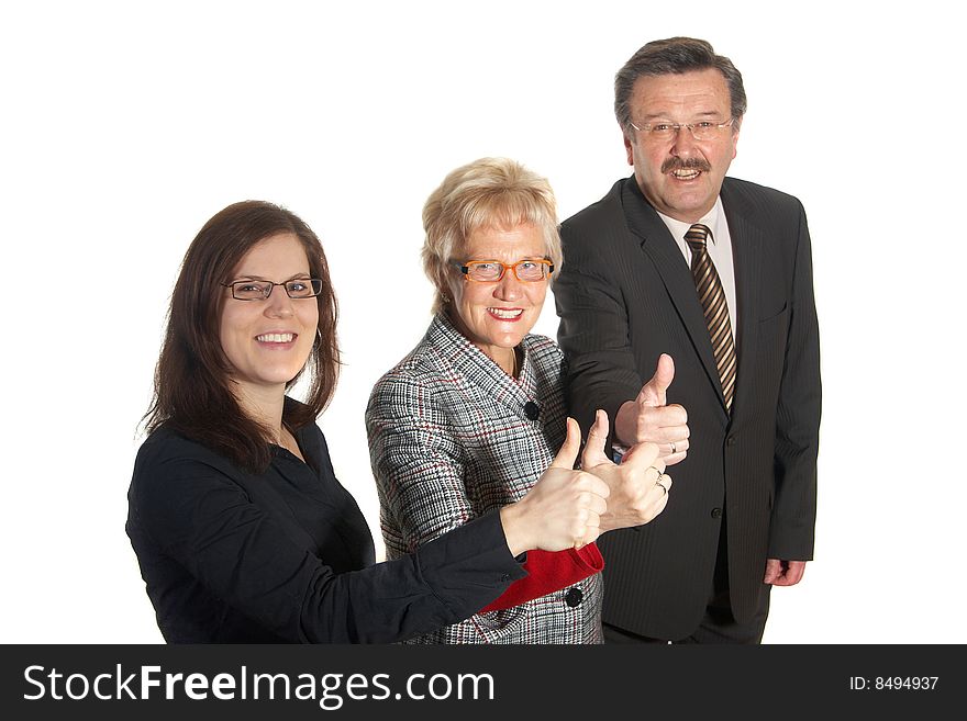 Small group of business people in business suits standing looking forward. Focus is on the young woman in front. Small group of business people in business suits standing looking forward. Focus is on the young woman in front.