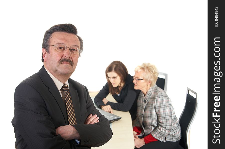 Businessman in office environment. Three people with focus on mature boss in front. Isolated over white. Businessman in office environment. Three people with focus on mature boss in front. Isolated over white.