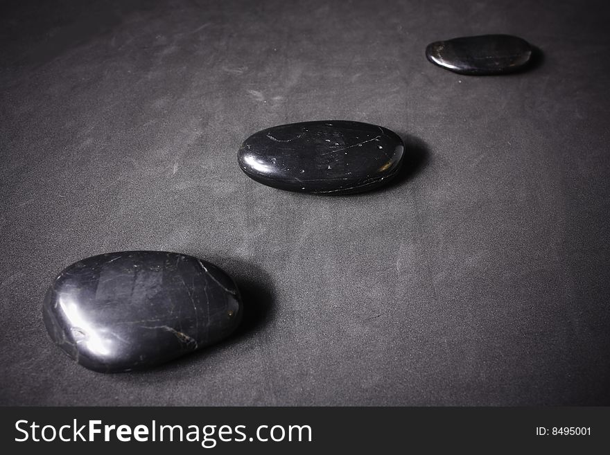 Zen stones on a gray background.