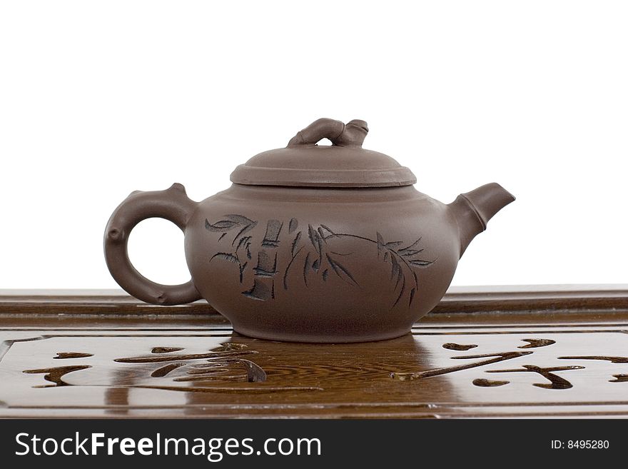 A teapot on a tea ceremony board on white background. A teapot on a tea ceremony board on white background