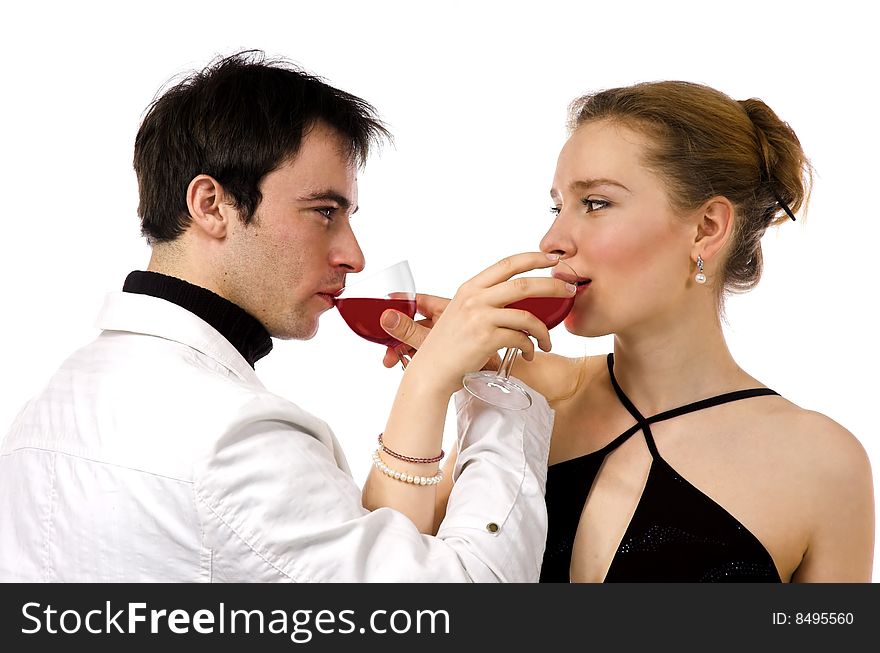 The man and the woman in white clothes with red wine. The man and the woman in white clothes with red wine