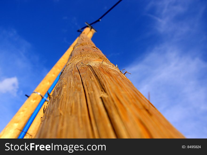 The background of blue skies and a high wooden pole