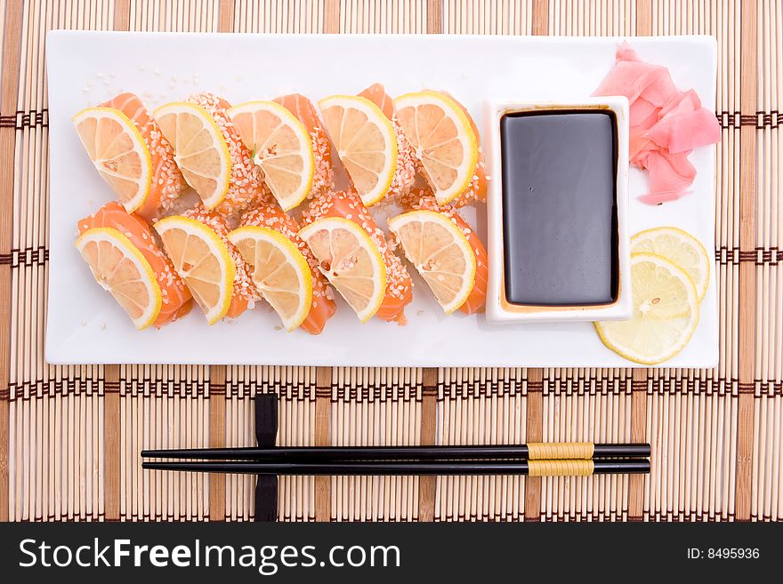 Plate with sushi and black chopsticks