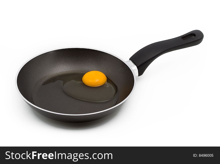 A raw egg in a pan isolated on white