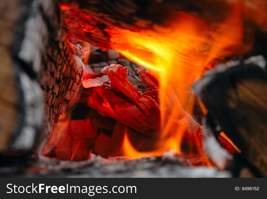 Firewoods and ash in flame as background