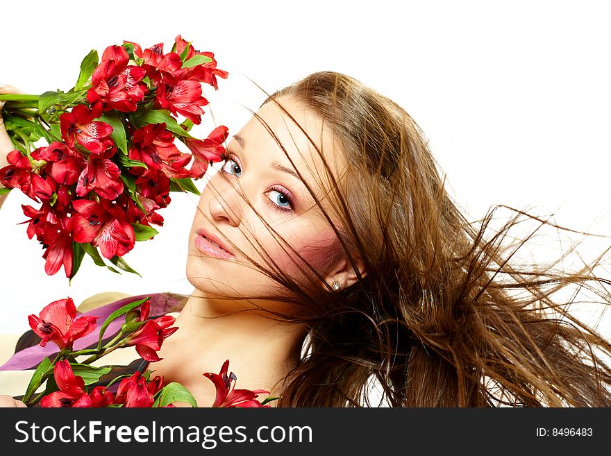 Attractive young woman with flowers, wind in hair. Attractive young woman with flowers, wind in hair