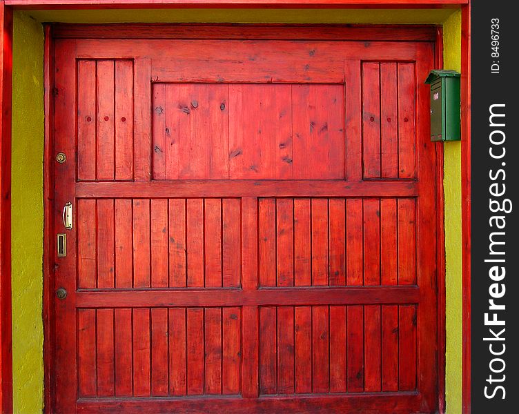 Colourful wooden door painted in bright red. Colourful wooden door painted in bright red