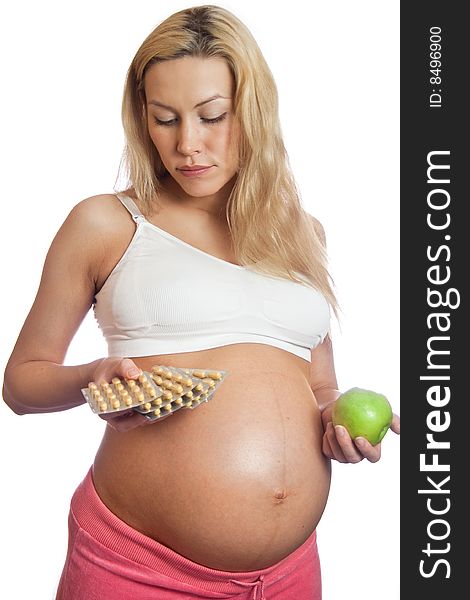 Pregnant woman with apple and tablets isolated on a white. Pregnant woman with apple and tablets isolated on a white