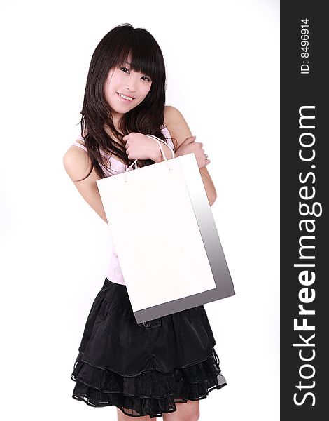 A beautiful Asian girl  holds a shopping bag  on white background. A beautiful Asian girl  holds a shopping bag  on white background.