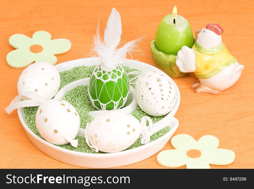 Easter decoration with eggs and candle on orange background. Easter decoration with eggs and candle on orange background