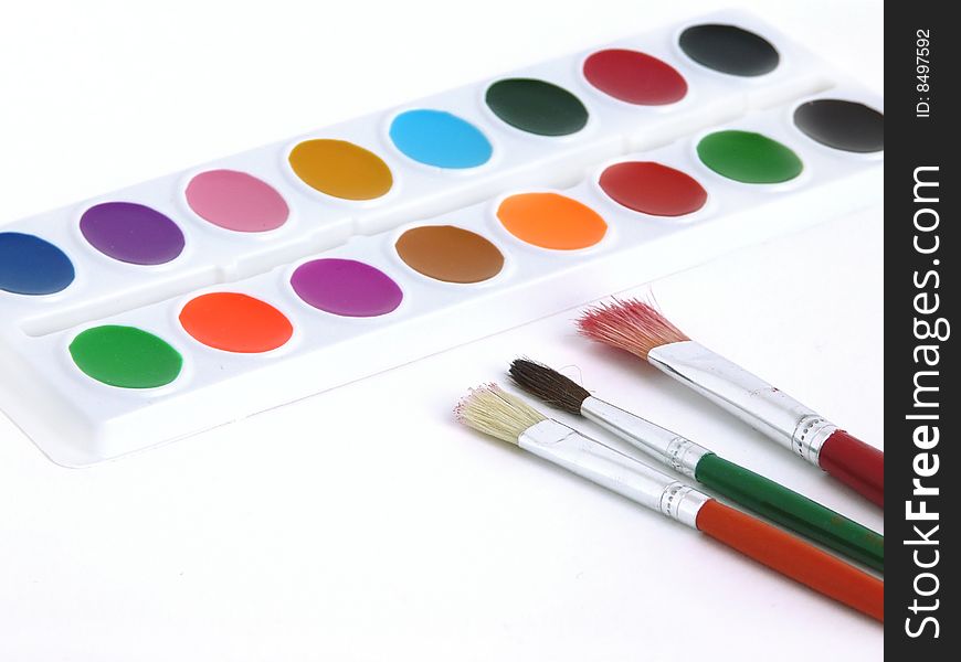 Paints and brushes isolated on white