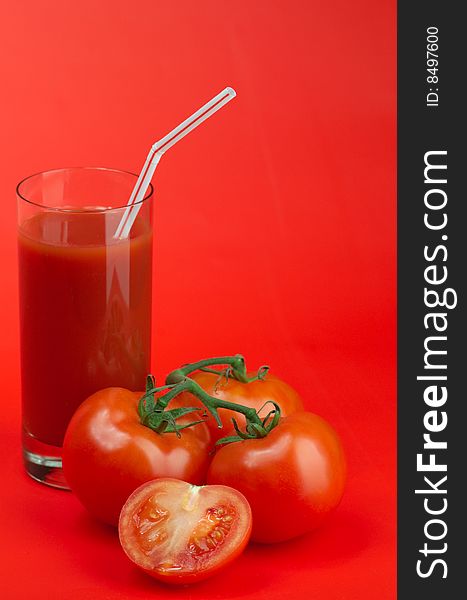 Ripe juicy tomatoes and glass of tomato juice. Ripe juicy tomatoes and glass of tomato juice