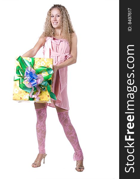 The young beautiful girl with a gift box on a color background. The young beautiful girl with a gift box on a color background