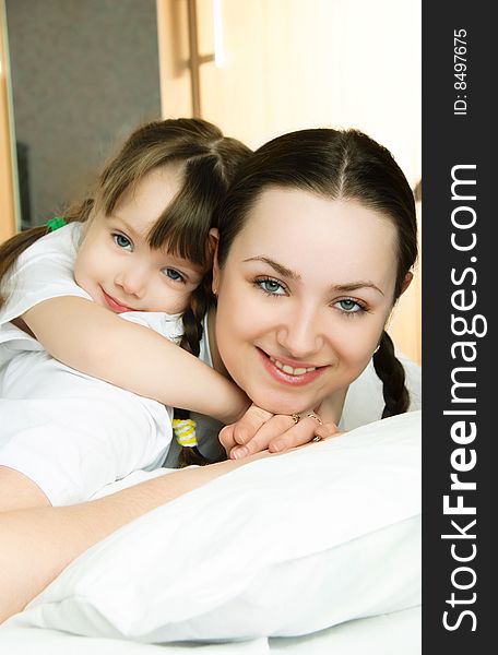 Mother And Daughter On The Bed