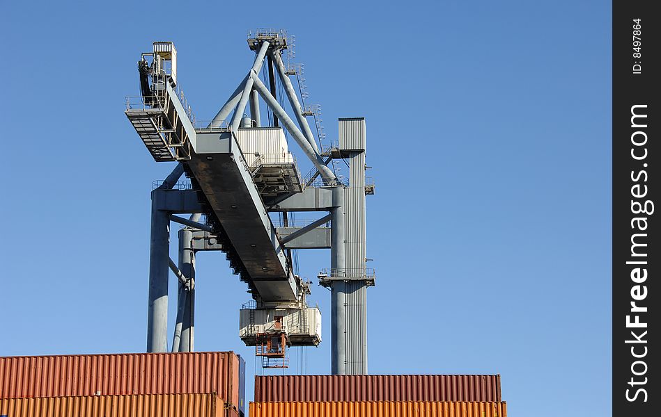 Large crane moving containers at the port