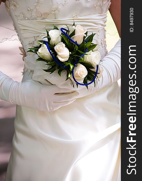 Bride in silk gloves hold beautiful bunch of flowers in her hands. Bride in silk gloves hold beautiful bunch of flowers in her hands