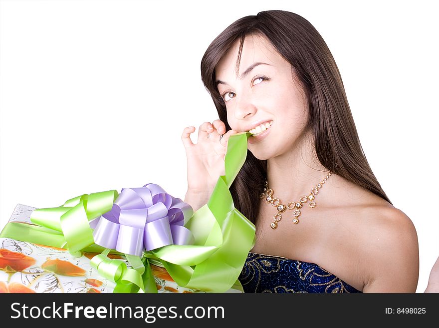 The young beautiful girl with a gift box on a color background. The young beautiful girl with a gift box on a color background