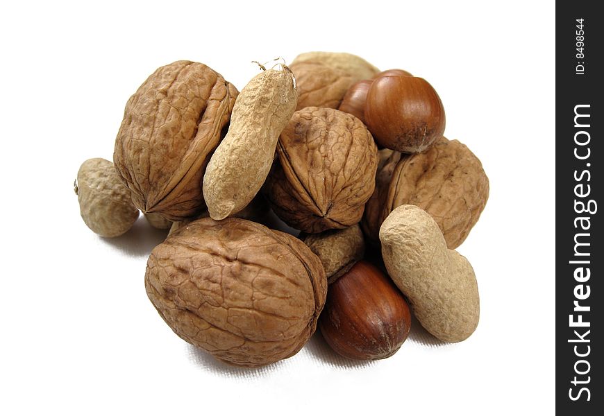 An assortment of nuts with their shells on. An assortment of nuts with their shells on