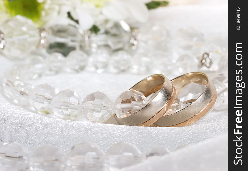 Closeup of wedding rings and beads