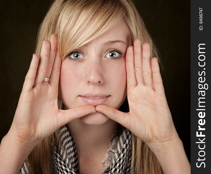 Pretty teenager framing her face with hands