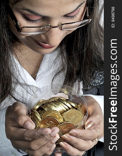 Girl with gold coins in studio.