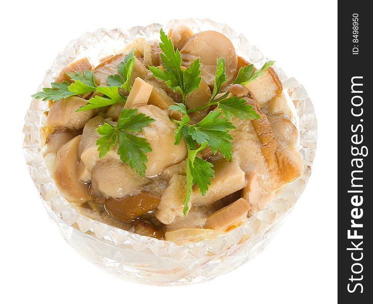 Pickled mushrooms in bowl with parsley, isolated on white