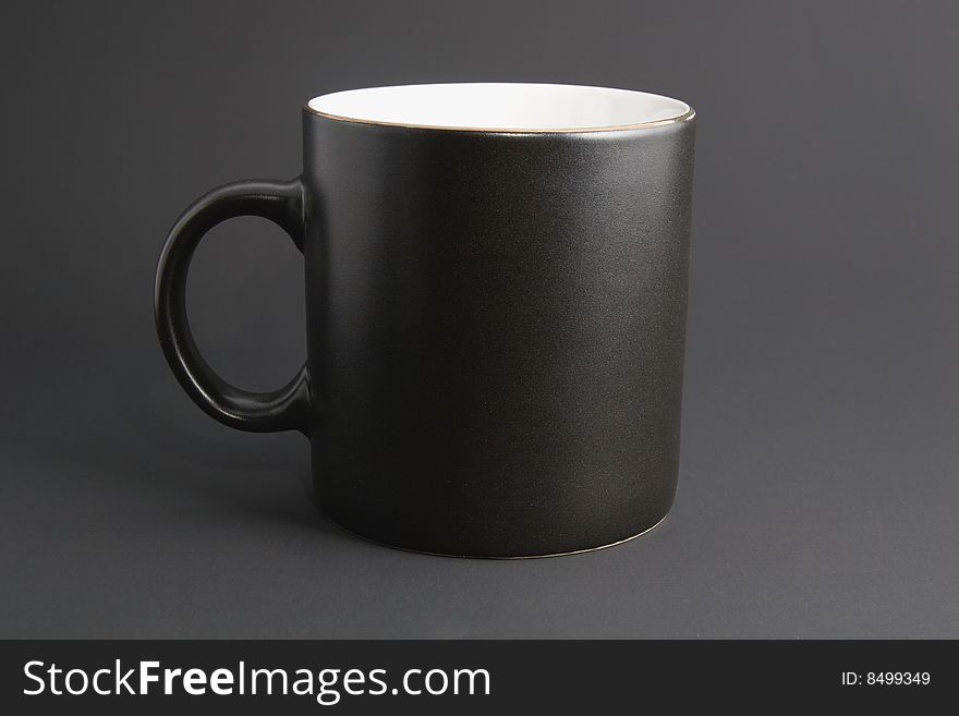 Dark office life: usual black coffee mug isolated on grey