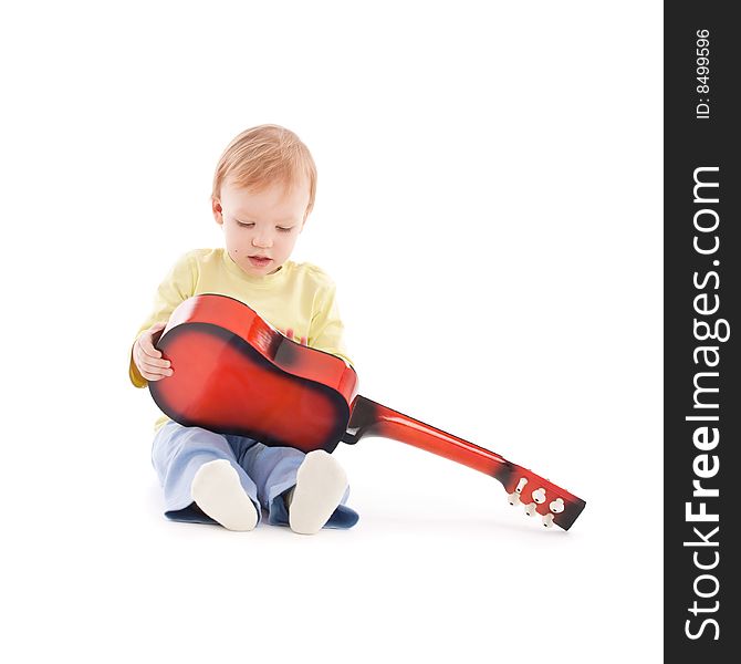 Portrait of the little boy with acoustic guitar over white background