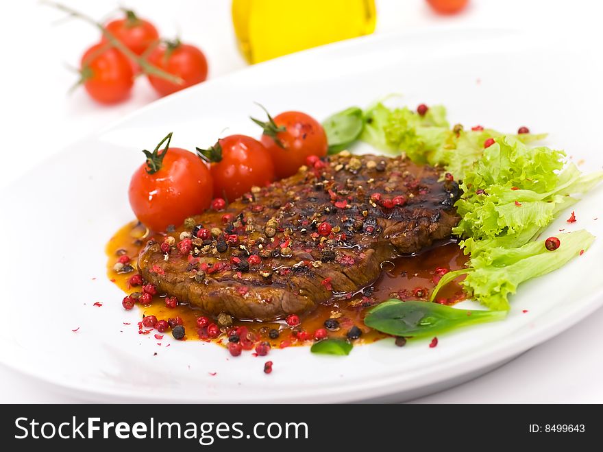 A Grilled Peppercorn - Steak With Tomato Lettuce