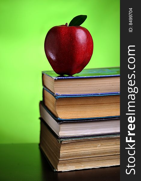 Stack of books with red apple, close up. Stack of books with red apple, close up