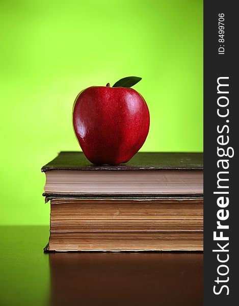 Stack of books with red apple, close up. Stack of books with red apple, close up