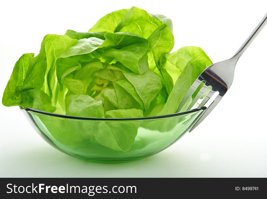 Green salad in a bowl and a fork. Green salad in a bowl and a fork