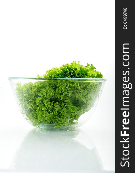 Green salad in a bowl on white background