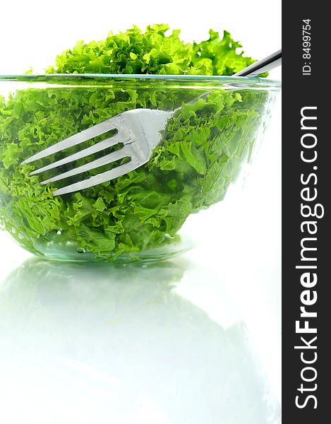 Green salad in a bowl and a fork